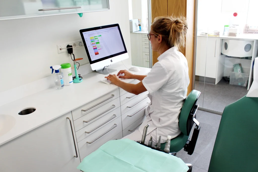 Dental clinician using an MMI keyboard in a treatment room