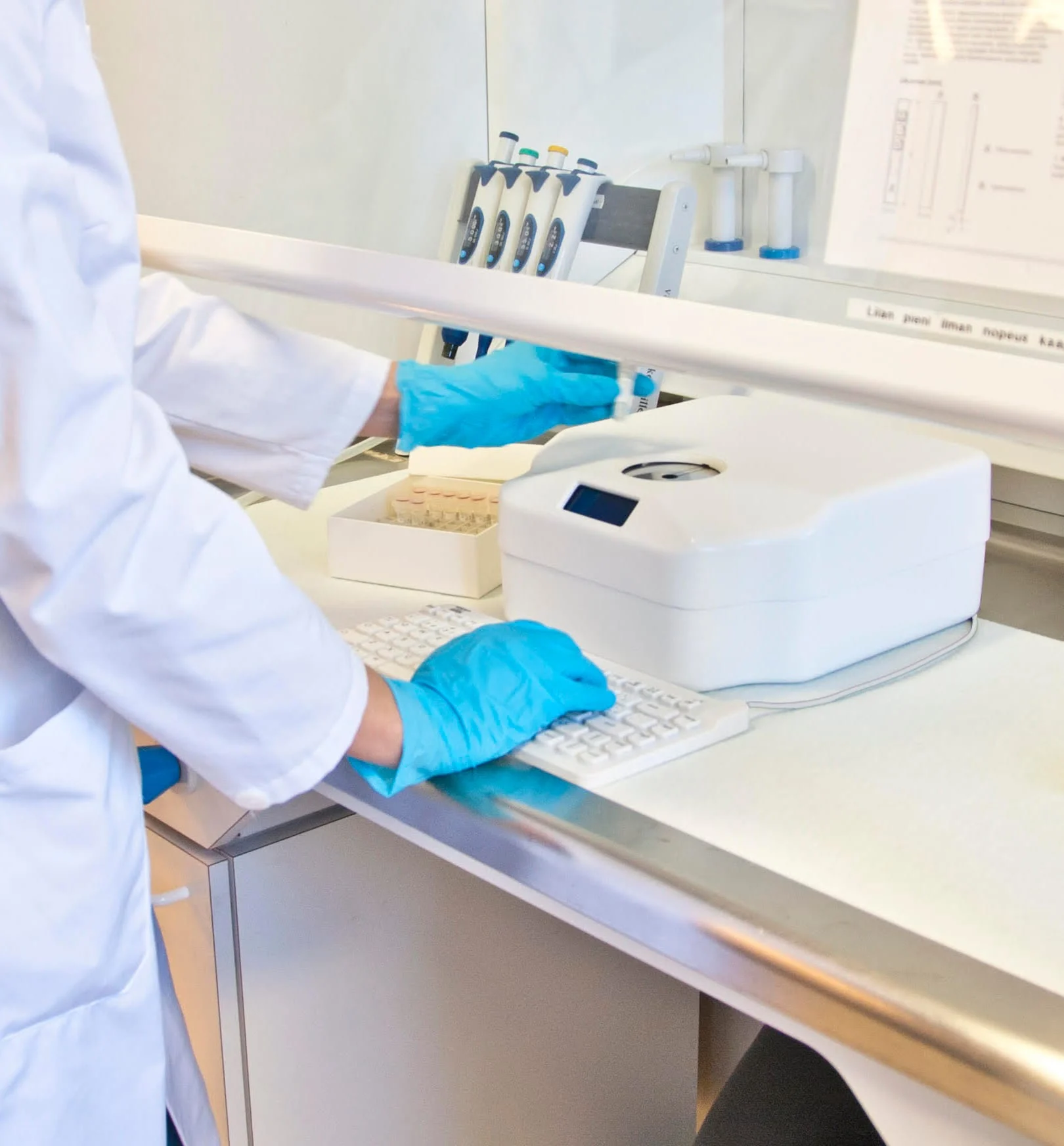 Technician using an MMI keyboard in a laboratory