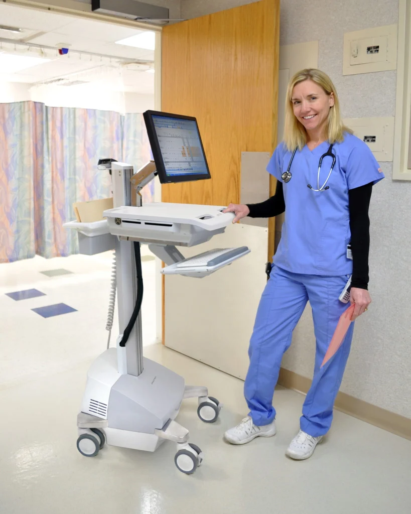 Clinician beside a mobile workstation equipped with an MMI keyboard