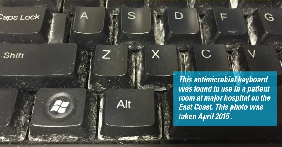 Photo labeled as an antimicrobial keyboard in a hospital patient room, with visible buildup around the keys; original photo dated April 2015