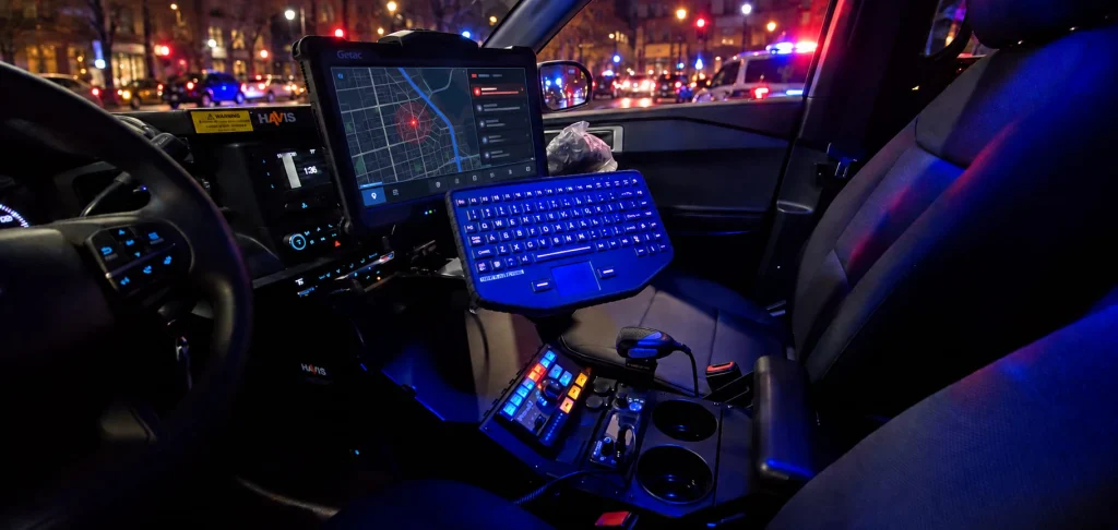 Mounted MMI keyboard and dispatch monitor inside a police vehicle at an evening call